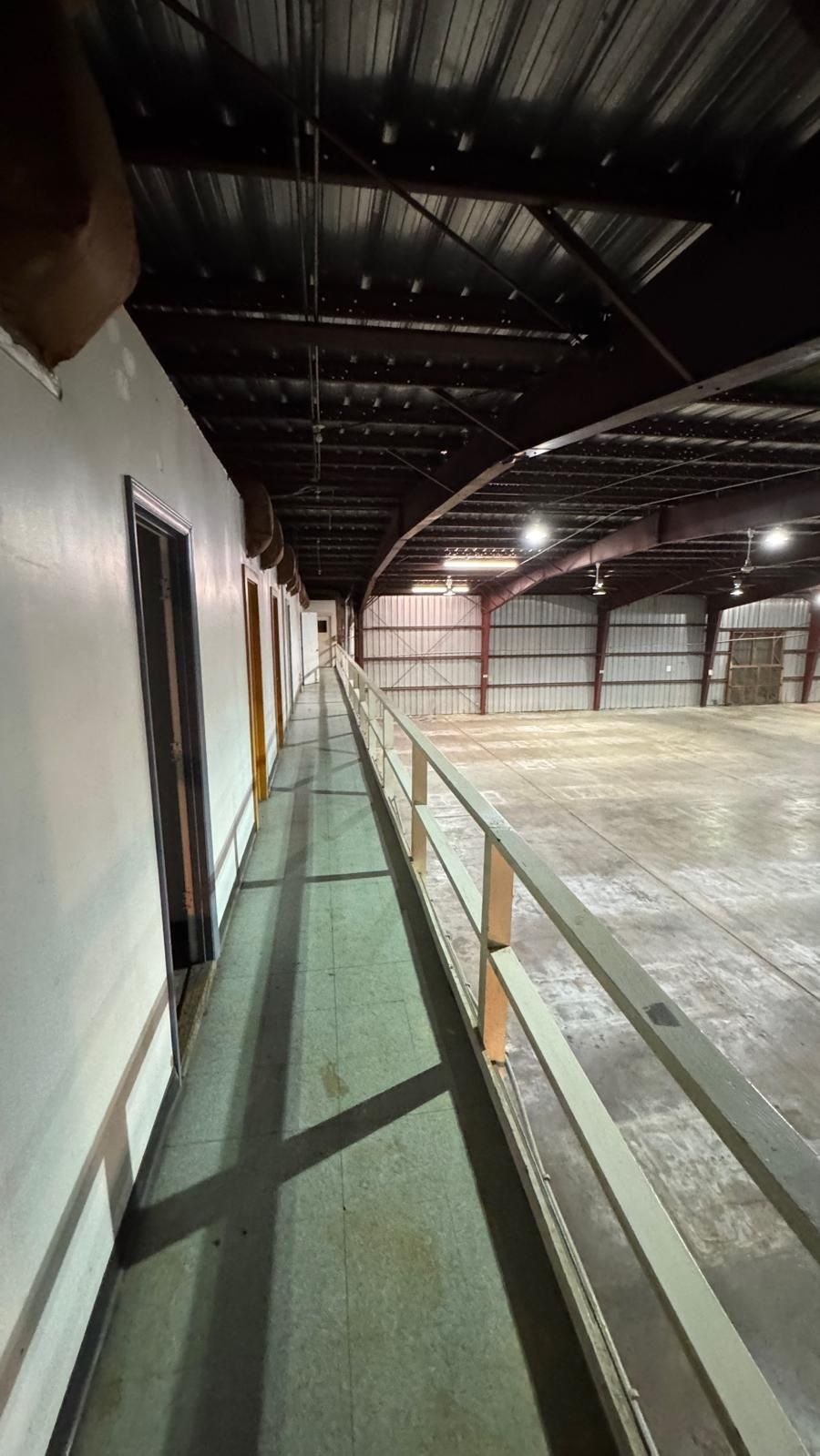 After: the mezzanine walkway overlooking an empty warehouse floor