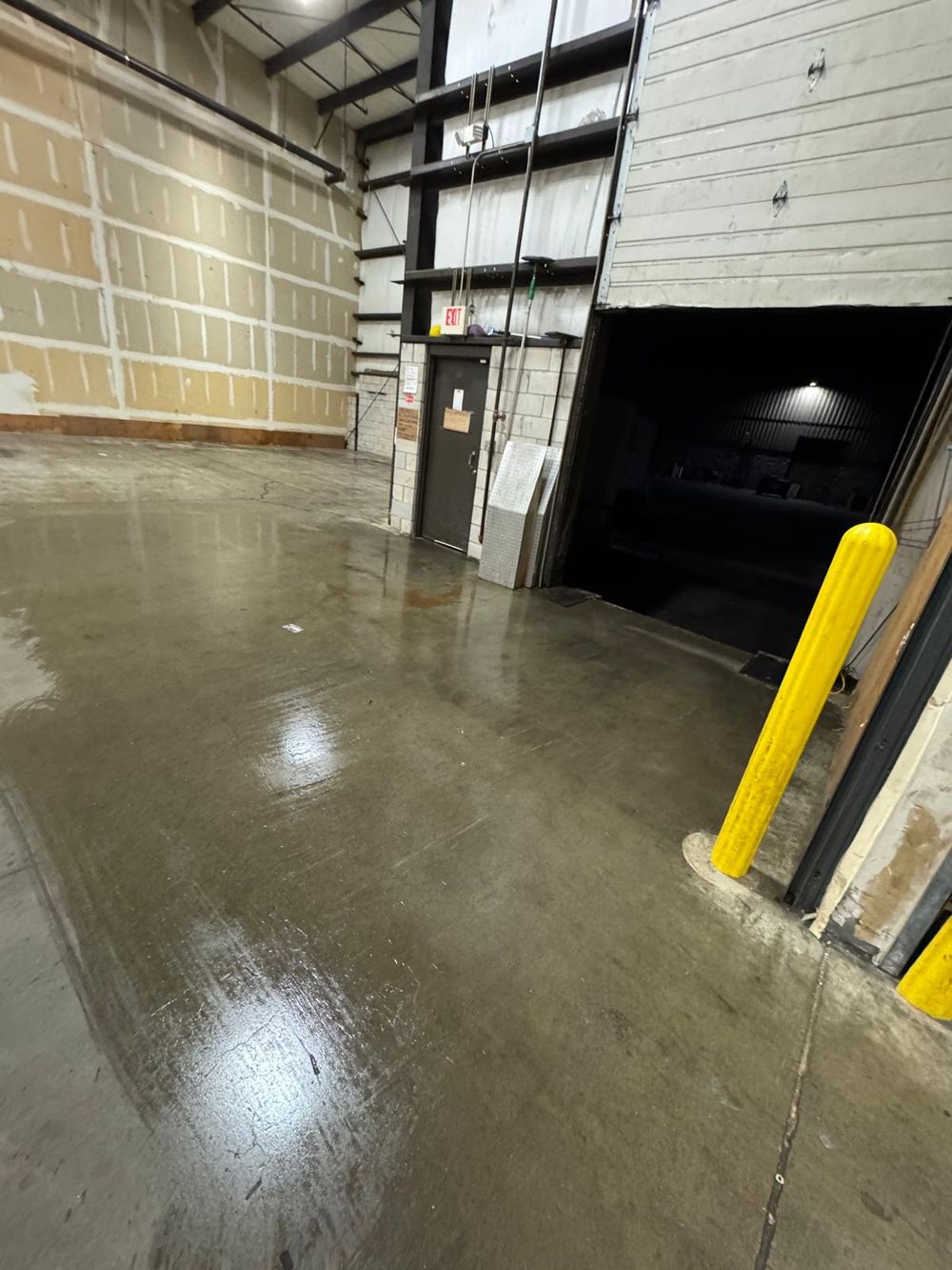 After: freshly washed concrete floor by the dock door